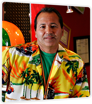 Dr. Albert Higgins wearing a bright yellow shirt with palm trees